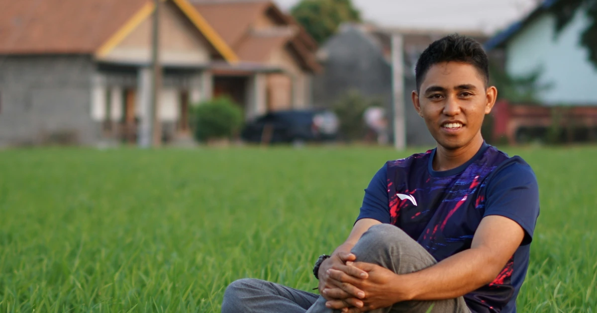 Alif Rasyid standing in a rice field outside Lampung